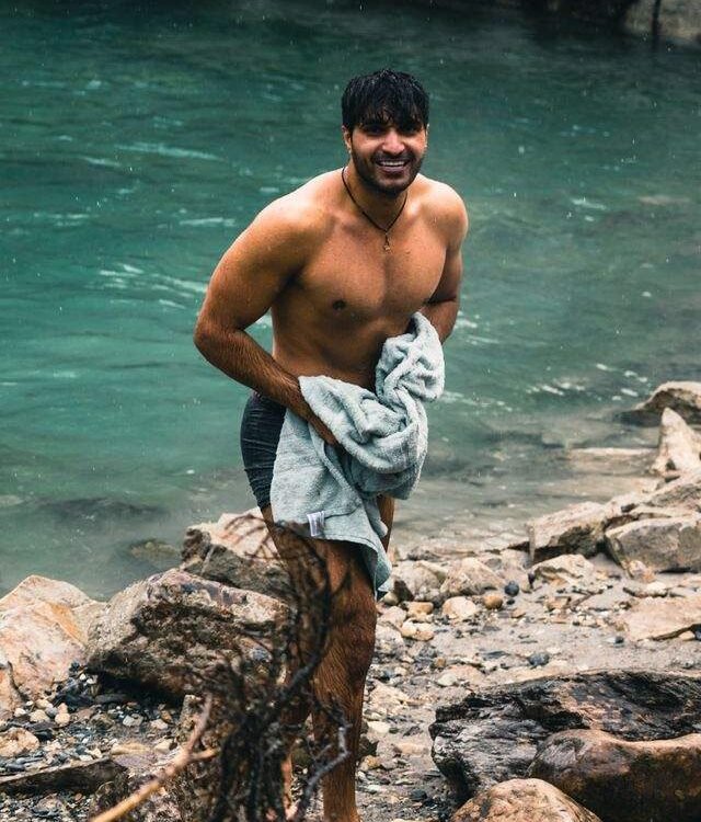 Person wrapping in a warm towel to rewarm after a cold plunge session